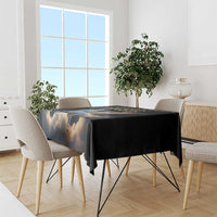 Black tablecloth draped over dining table with blue Pegasus wing print