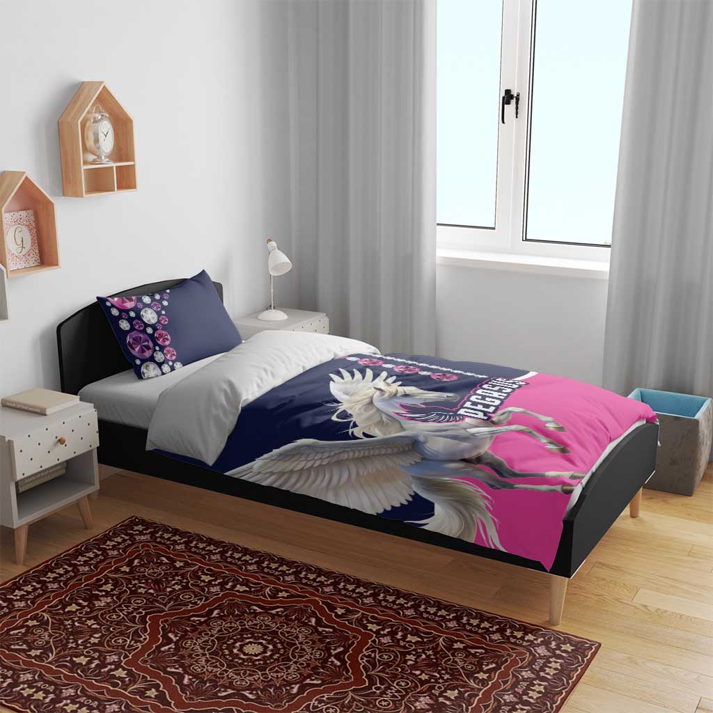 Navy and pink Pegasus bedding set on bed, with winged Pegasus artwork and jewel-pattern pillows