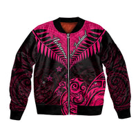 Pink and black zip-up bomber jacket with ribbed hem and front Maori-style artwork