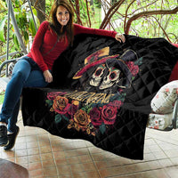 Black quilt stretched by person, showing couple skulls, roses, and “Valentine” design