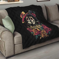 Black quilt draped on sofa with couple skull and rose artwork and “Valentine” text