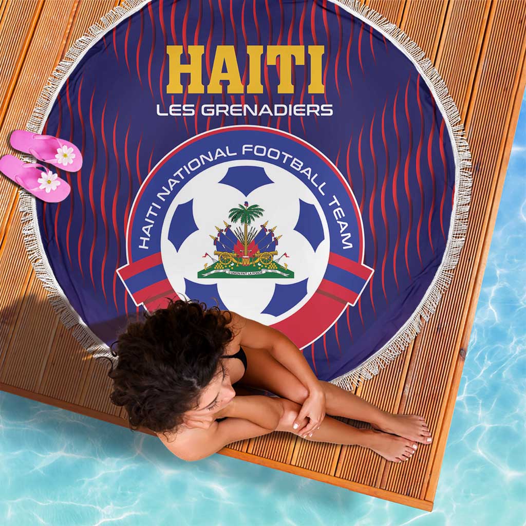 Round blue football beach blanket with red stripes, team crest, and white fringe edge.