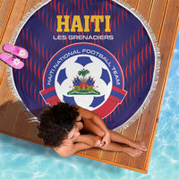 Round blue football beach blanket with red stripes, team crest, and white fringe edge.