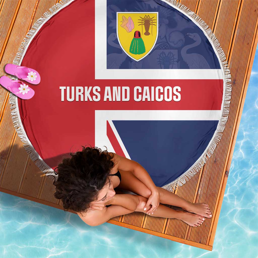 Round beach blanket showing Turks and Caicos crest and text, red white blue, fringed