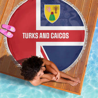 Round beach blanket showing Turks and Caicos crest and text, red white blue, fringed