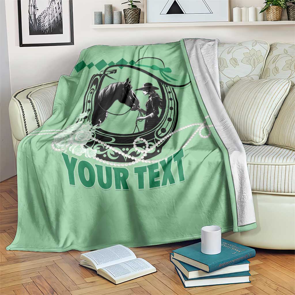 Green personalized horse racing blanket draped on a couch with large “YOUR TEXT”
