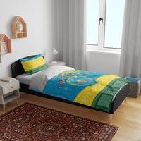 Blue Rwanda bedding set with coat of arms design and African geometric pattern on a bed