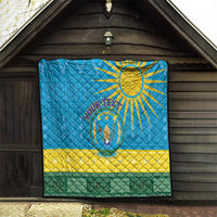 Blue quilt blanket hanging indoors with sun emblem, yellow stripe and green border