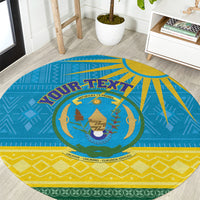 Round blue Rwanda coat-of-arms rug with yellow, green accents and tribal-style border