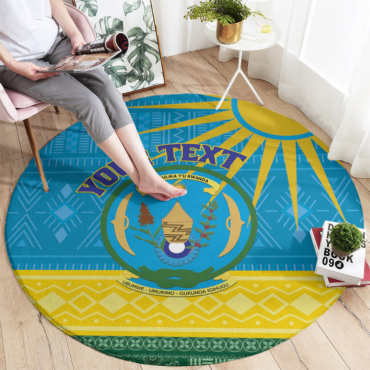 Round blue Rwanda rug showing large coat-of-arms center and gold sunburst rays