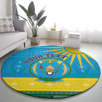 Round blue Rwanda rug with coat-of-arms medallion, yellow border, and green details
