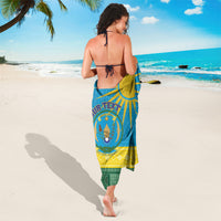 Blue sarong coat with Rwanda crest medallion and African pattern, tie-back drape