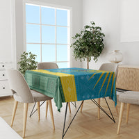 Personalized tablecloth with green geometric pattern and blue-yellow border on dining table
