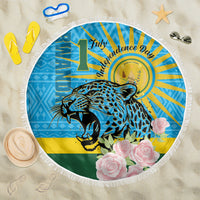 Round blue beach blanket with leopard graphic, roses and fringe edge.