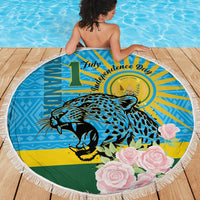 Round blue beach blanket, leopard graphic with roses and white tassel fringe edge.