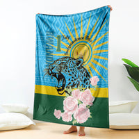 Leopard and rose graphic blanket with blue sunburst rays and green base, standing