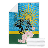 Leopard and rose graphic blanket with blue sunburst, shown with folded white towels