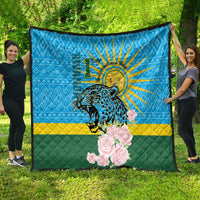 Blue quilt spread outdoors: leopard graphic, sunrays, pink roses, green-yellow stripe.