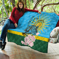 Blue quilt draped on patio sofa with leopard, sunrays, pink roses, green-yellow stripes.