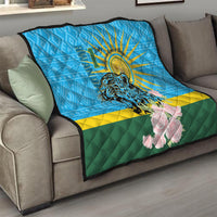 Blue quilt on gray couch with leopard face, sunrays, pink roses, green-yellow stripe.