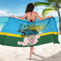 Blue-green sarong with leopard emblem and large pink rose clusters on hem