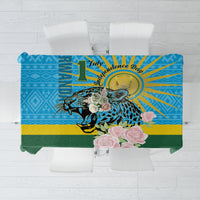 Blue tablecloth with leopard print, roses, and Rwanda-style anniversary graphic
