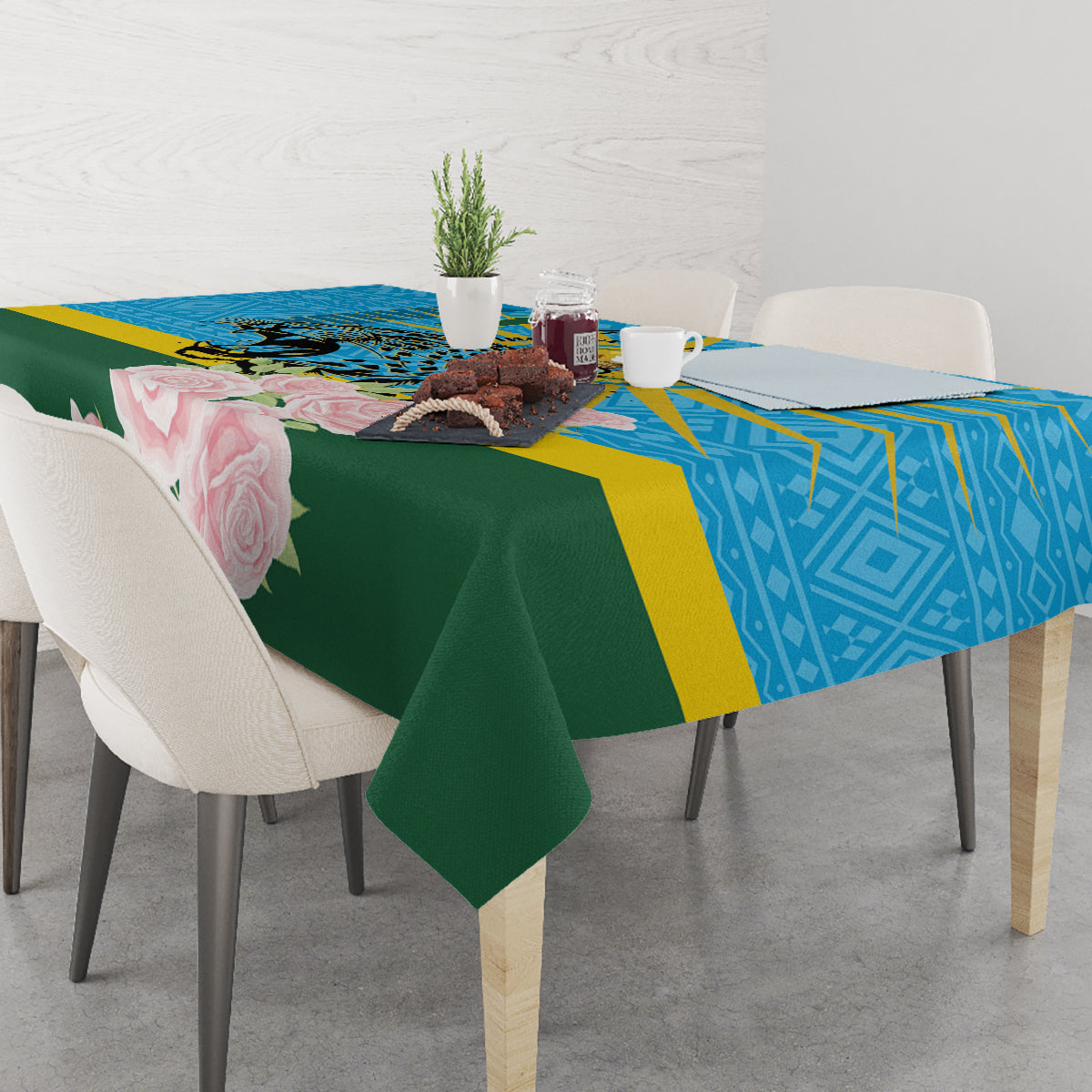 Tablecloth draped over square table: blue geometric band, green center, roses