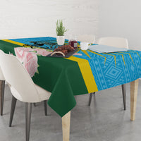 Tablecloth draped over square table: blue geometric band, green center, roses