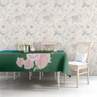 Tablecloth on dining table with pink rose print over green base, blue border