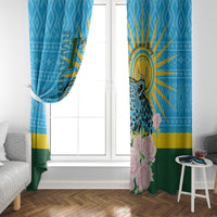 Blue window curtain panels with leopard and roses, partially covering a window opening.