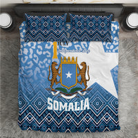 Blue Somalia bedding set with white shield, leopard figures, and geometric diamond pattern