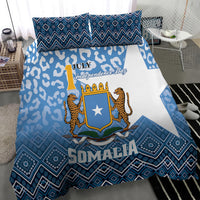 Blue and white bedding set with shield logo, leopard figures, and blue geometric trim