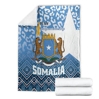Folded blue and white Somalia blanket with leopard shield star emblem and July Independence Day