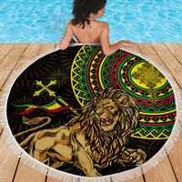 Round beach blanket featuring a roaring lion and circular Ethiopian-style design, with white fringe