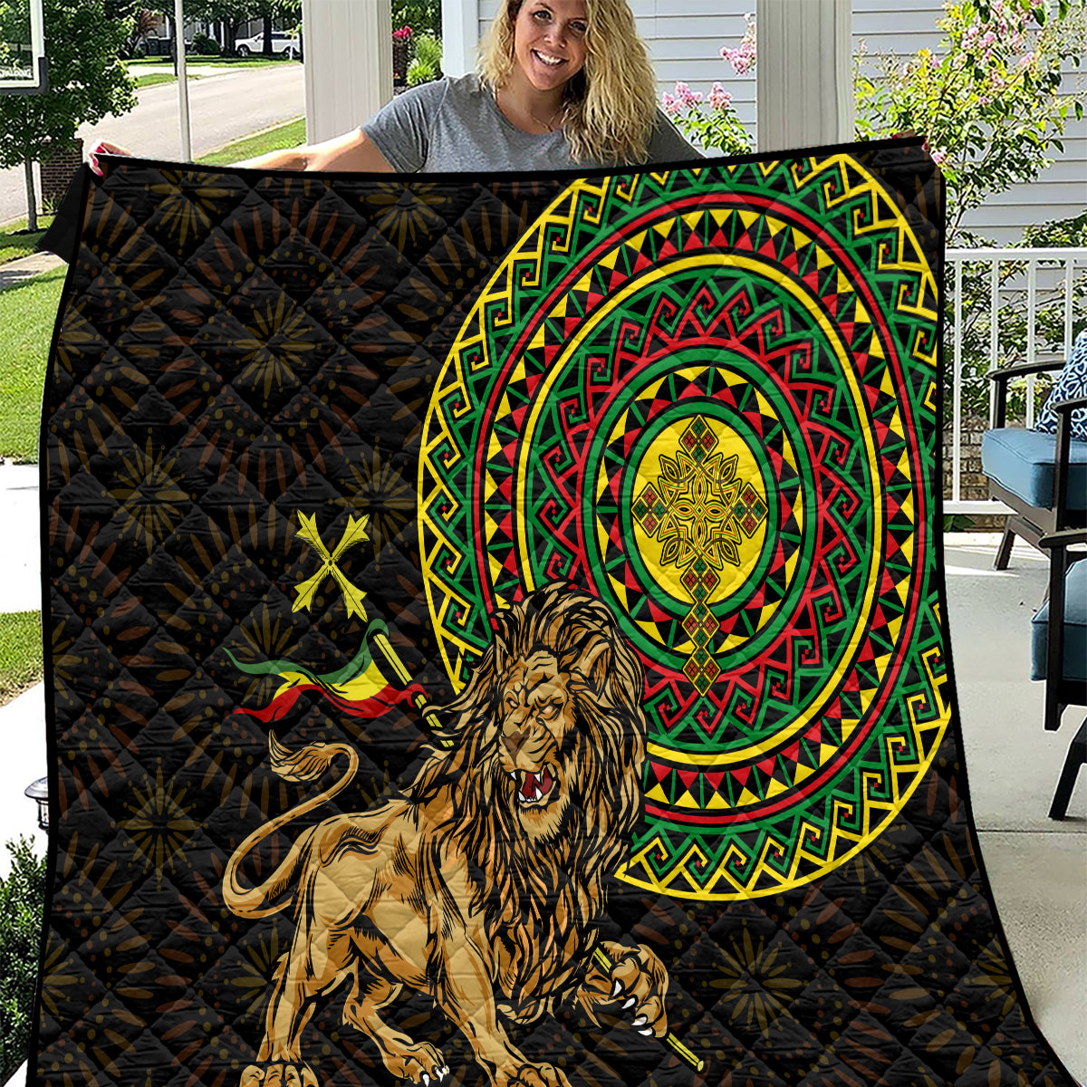 Black quilt featuring lion design, Ethiopian circular pattern, and colorful cross-stitch stars