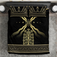 Black bedding set with gold central crest, star details, and ornate border on duvet