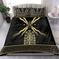 Black duvet and matching pillowcases with gold emblem, flowing curves, and decorative trim