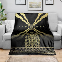 Black and gold patterned mythological blanket draped over sofa with central throne emblem