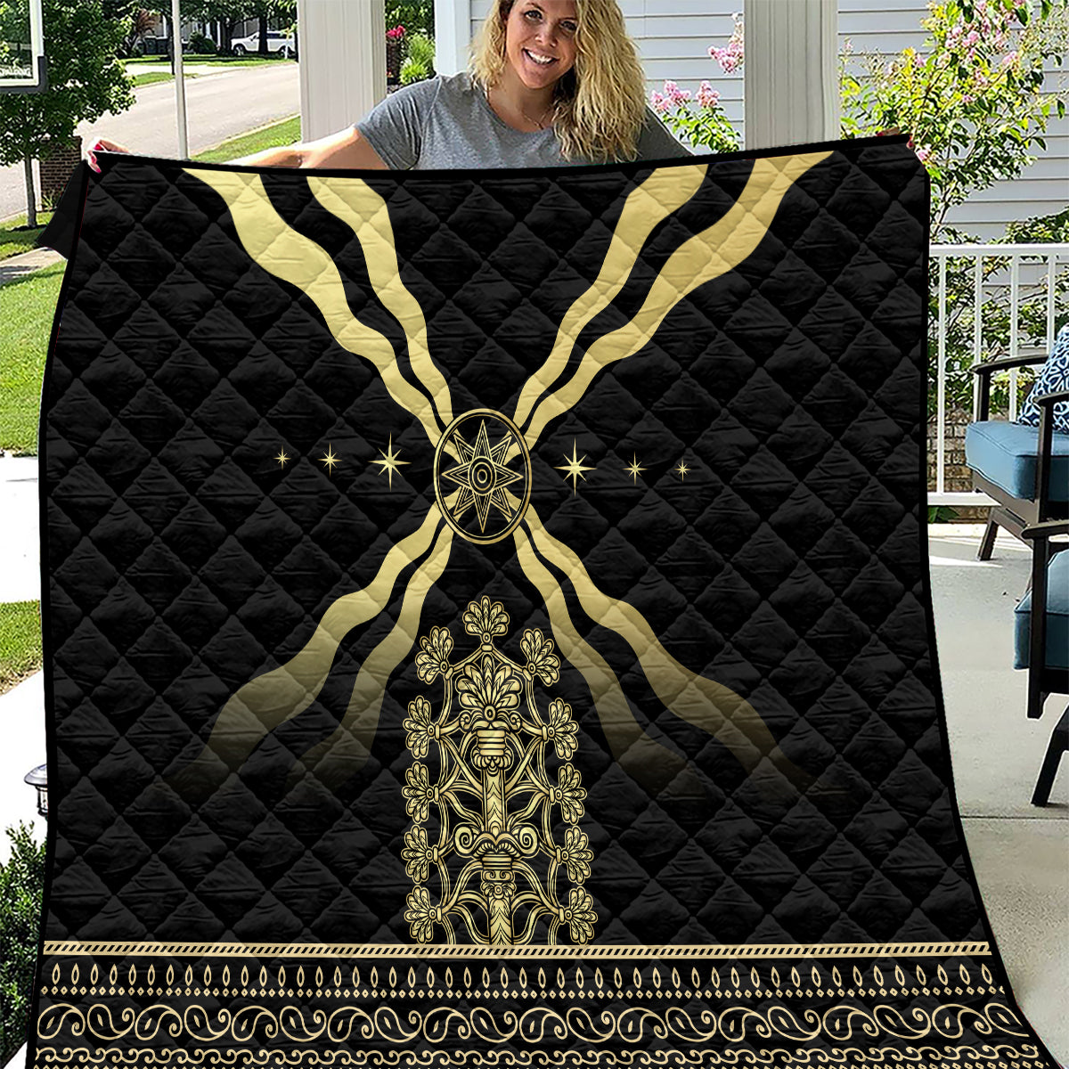 Black quilt blanket with gold cross pattern, central emblem, and ornate border