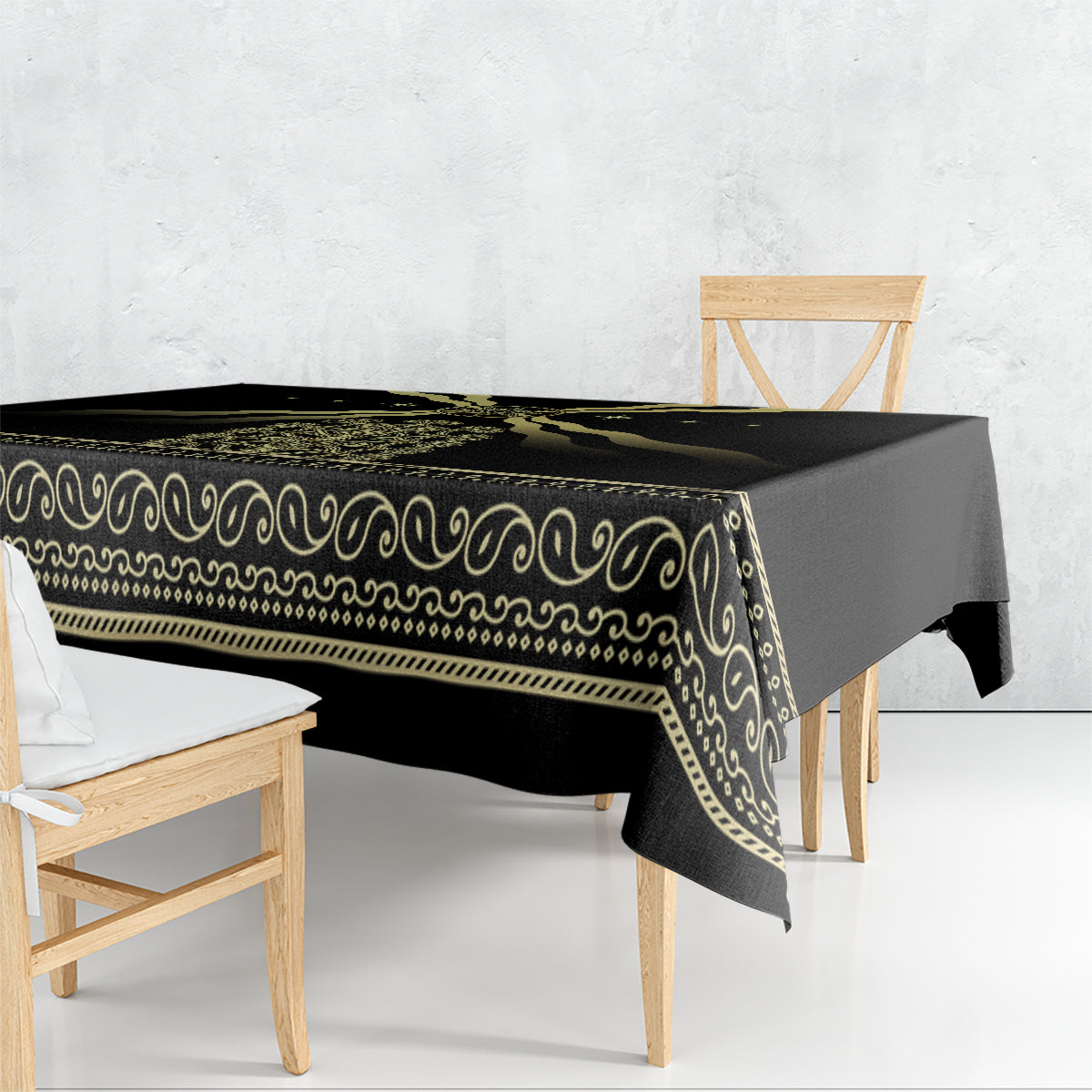 Black tablecloth with gold ornamental border and repeating swirl pattern