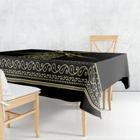 Black tablecloth with gold ornamental border and repeating swirl pattern