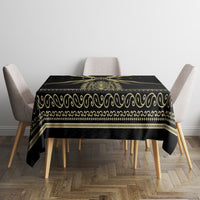 Black tablecloth with gold wave and scroll trim along the edges
