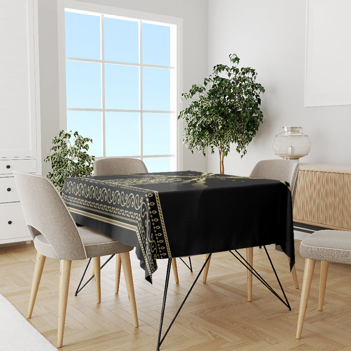 Black tablecloth with gold striped border and repeating swirl ornament