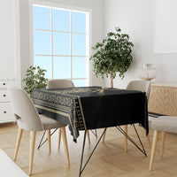 Black tablecloth with gold striped border and repeating swirl ornament