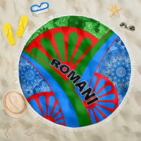 Round beach blanket with fringe, Romani text on green-red-blue rays and white border