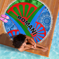 Round beach blanket with fringe, Romani text on green-red-blue rays, blue patterned sides