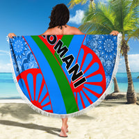 Round beach blanket with fringe, Romani text with green-red-blue rays, blue ornate side panels
