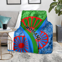 Green, blue, and red Roma pattern blanket on a gray sofa
