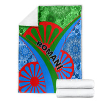 Roma pattern blanket with white towels stacked beside it