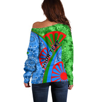 Women's off-shoulder sweater back view, Romani fan graphic with diagonal text detail